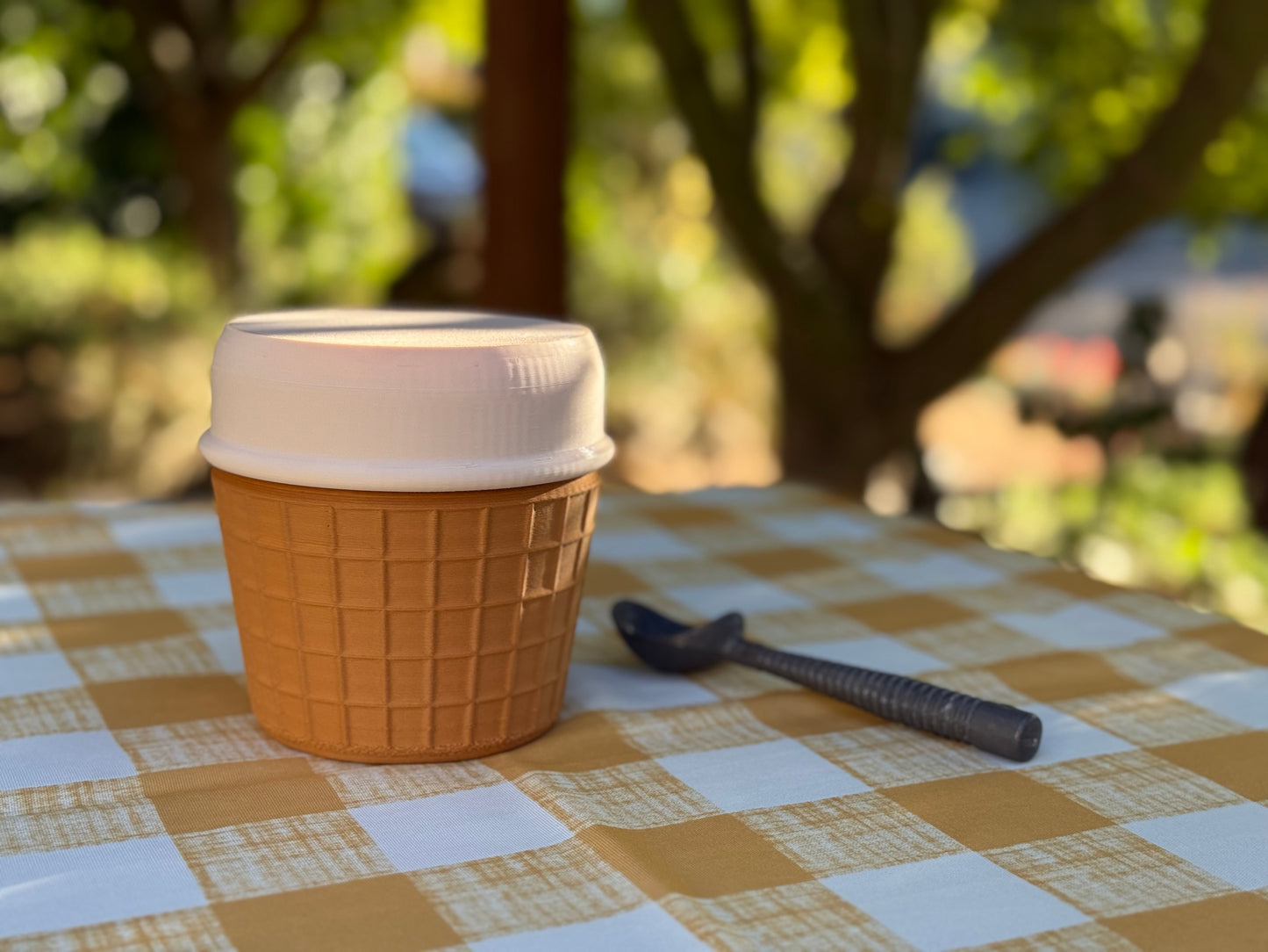 Portable Ice Cream Cooler container with lid on a checkered tablecloth,outdoors, Ice Cream portable cooler, ice cream pint cooler